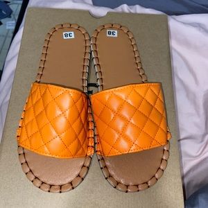 Leather orange sandals.